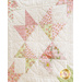 Quilt block with geometric square and triangle designs made of pastel color fabrics on white.