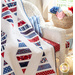 White quilt with diamonds made of strips of red white and blue patriotic fabrics.