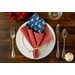 Reversible cloth napkin, one side printed with sheep wearing a US flag on blue, the other with red and white gingham.