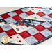 Table runner made of checkerboard squares arranged into diagonals. Made of white, red, and blue fabric.