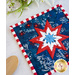 Round pad with central folded star design made of red, white, and blue patriotic fabrics.