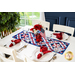 A beautiful white table set with patriotic decor and a geometric red, white, and blue table runner