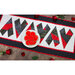 Top down image of crazy hearts table runner with a plate of red frosted cookies and roses scattered around