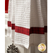 White waffle textured towel with red banding featuring squares, stars, and diamonds.
