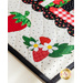 Table runner made of strawberry themed fabrics and featuring strawberry shaped appliqué on the ends.