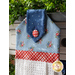 Hanging towel featuring a blue floral print and red and white plaid accents.