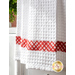 White waffle textured towel with red and white plaid band.
