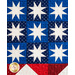 Close up of quilted United States flag with chevron stripes and geometric stars