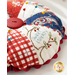 Round pin cushion made from triangle pieces of fabric with patriotic embroidery and a button middle.