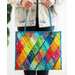 woman holding a handmade bag with a diamond pattern in rainbow colors