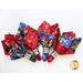 4 cloth napkins made of red and blue floral prints with silver napkin holders on a white background