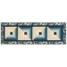 Isolated image of Log Cabin Table Runner featuring blue and cream fabric strips in three squares that decrease to the centers with a floral fabric border