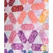 A colorful quilt featuring geometric star patterns in shades of pink, purple, and blue.