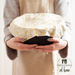 Woman holding a bowl covered by a fabric beeswax wrap