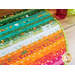 Colorful quilted fabric featuring vertical stripes of green, orange, and pink with floral patterns.