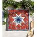 Square hot pad with central folded star design made of red and blue fabrics featuring paisleys.