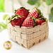 An image of a full basket of strawberry pincushions.