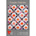 Front cover of Pumpkin Patches Pattern featuring a finished quilt made in white, orange, and mixed purple accents