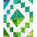 A colorful green, teal, and yellow batik block on a white quilt background