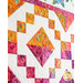 Orange, pink, and yellow diamond batik block on a white quilt background