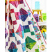 Colorful batik diamond blocks on a white quilted background draped on a wall