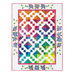 A large white quilt with colorful diamond blocks hung on a white background