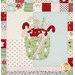 Quilt block featuring candy canes and an angel in a container.