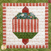 A close-up block of an ornament in Christmas fabrics.