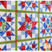 9 block geometric quilt made with red, White, and blue floral fabrics.