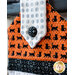 Black, orange, and white hanging towel with black cat print and black accents.