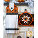 Black, orange, and white hanging towel with black cat print and black accents Next to matching hot pad.