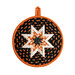 Round hot pad made of black fabric with candy corn print along with orange and white accent fabrics.
