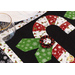 Black and white table runner featuring 3 candy canes with fabric yo-yos, all made of Winter themed fabric prints.