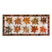 Table runner with two rows of maple leaves made of autumn themed prints on cream background.
