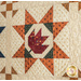 Cream colored autumn themed quilt featuring leaves and geometric designs.