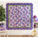 finished quilt hung on a white wall, illustrating the square shape and scalloped edges