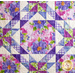 detail of quilt block with alternating triangles rippling out from a center square