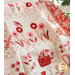 Cream, pink, and red quilt featuring flowers and animals draped over furniture.