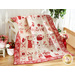 Cream, pink, and red quilt featuring flowers and animals draped over furniture.