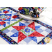 A red, white, blue, and green geometric table runner quilt block made of floral fabrics