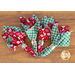 Cluster of 4 red and green napkins fanned together on a wood background