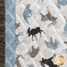 close up of one quilt block edge showing taupe and dusty blue fabrics with bears, moose, and geometric shapes on them.