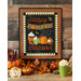 An autumn themed wall hanging with cups of cocoa, leaves, and pumpkins on a wooden wall