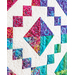 A quilt featuring colorful patchwork squares and diamond shapes with intricate quilting patterns.