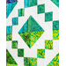 Colorful quilt featuring geometric patterns in shades of blue and green against a white background.