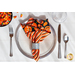 A Too Cute to Spook striped Cloth Napkin on a plate.