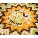 Folded star table topper with whimsical halloween prints in orange, cream, and green.