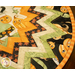 Folded star table topper with whimsical halloween prints in orange, cream, and green.
