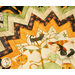 Folded star table topper with whimsical halloween prints in orange, cream, and green.