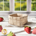 Basket made of woven neutral plaid fabrics surrounded by strawberries made of fabric.